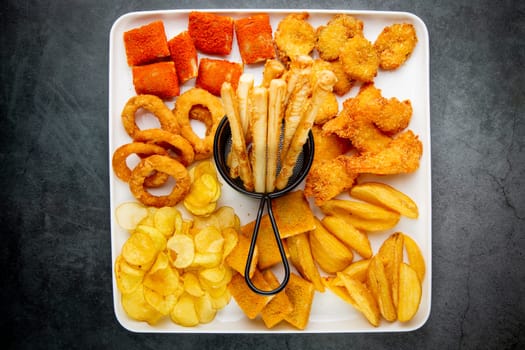 beer set with nuggets, breaded onion rings, fries and sauces