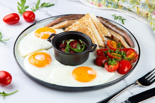 Breakfast of eggs and vegetables with cherry tomatoes and slices of bread