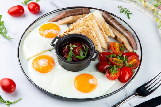 Breakfast of eggs and vegetables with cherry tomatoes and slices of bread