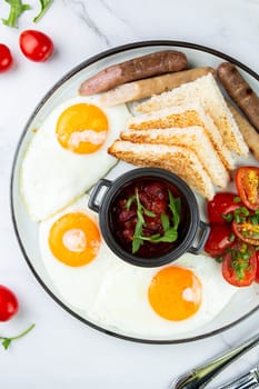 Breakfast of eggs and vegetables with cherry tomatoes and slices of bread