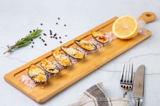 oysters scallops with red sea salt and citric acid on a wooden tray