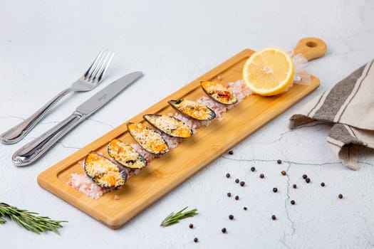 oysters scallops with red sea salt and citric acid on a wooden tray