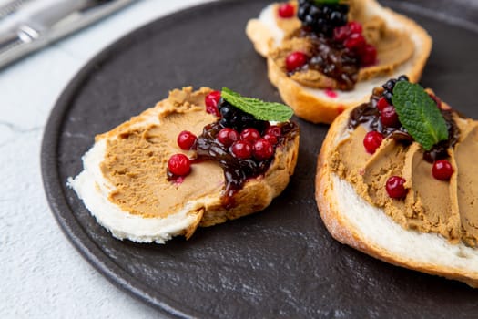 canapes with pate, mint leaves and berries