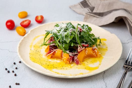 green salad with arugula and lingonberries on a white plate and marble background