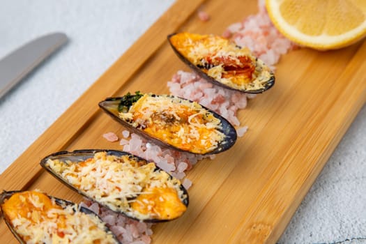 oysters scallops with red sea salt and citric acid on a wooden tray