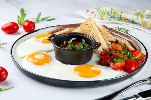 Breakfast of eggs and vegetables with cherry tomatoes and slices of bread