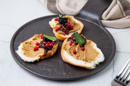 canapes with pate, mint leaves and berries