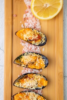 oysters scallops with red sea salt and citric acid on a wooden tray