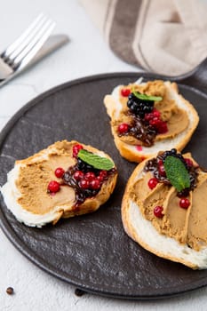 canapes with pate, mint leaves and berries