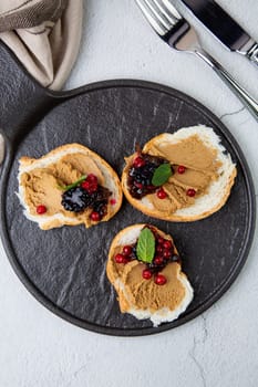 canapes with pate, mint leaves and berries