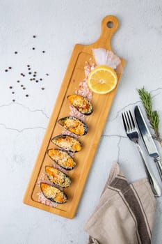 oysters scallops with red sea salt and citric acid on a wooden tray