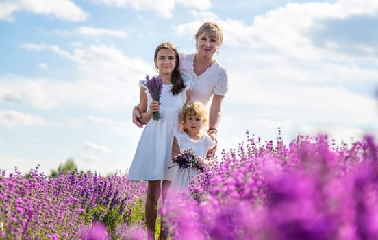Mother and children in a lavender field. Selective focus. Nature.
