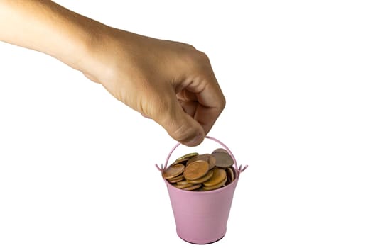 Hand holding a small bucket of coins on white background. High quality photo