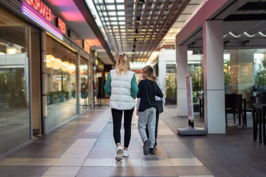 A family walks down the the shops. mother and children. day. High quality photo