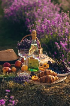 Picnic with wine in a lavender field. Selective focus. Nature.