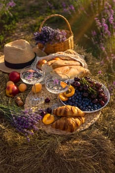 Picnic with wine in a lavender field. Selective focus. Nature.