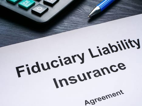 Fiduciary liability insurance agreement and a calculator.