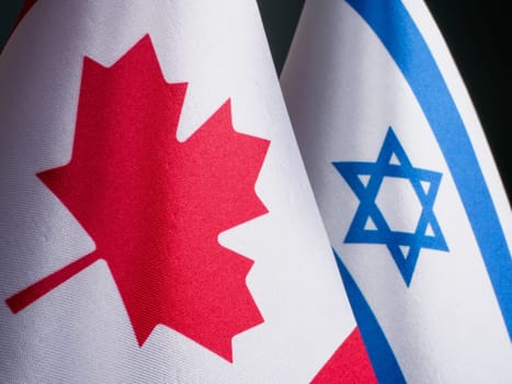 Nearby are the small flags of Canada and Israel.