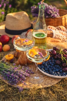 Picnic with wine in a lavender field. Selective focus. Nature.