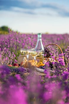 Picnic with wine in a lavender field. Selective focus. Nature.