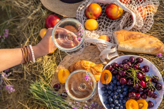 A woman drinks wine in a lavender field. Selective focus. Nature.