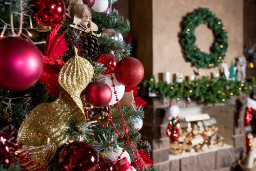 Christmas, New Year interior with red brick wall background, decorated fir tree with garlands and balls, dark drawer and deer figure