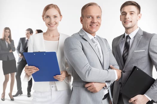 Smiling business leaders and their team isolated on white background