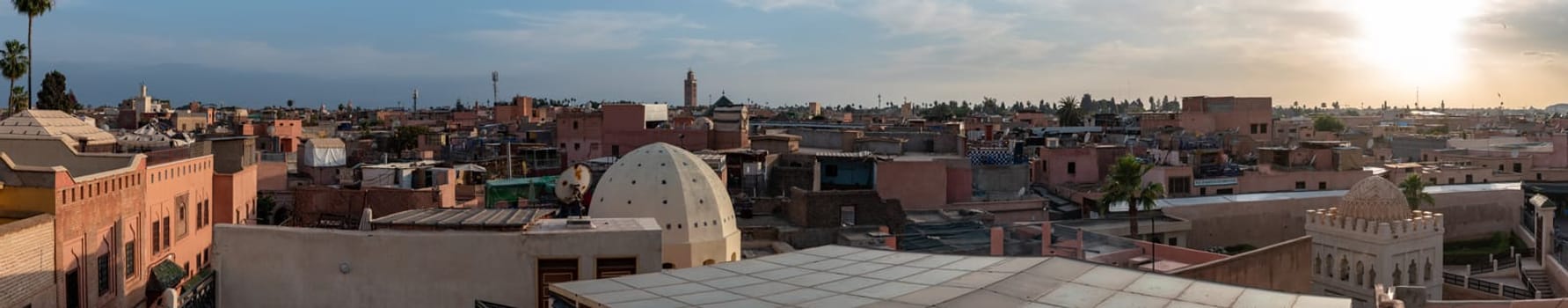 Panoramic view of the medina of Marrakech, the coupola of the Koubba Almoravid in the right side, seen from a rooftop, Morocco