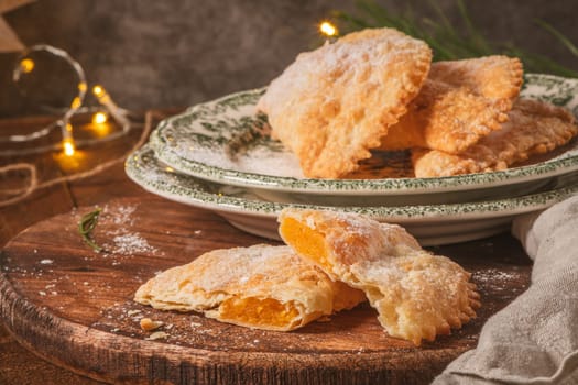 A crescent-shaped pastry whose filling is made of eggs and almonds wrapped in crispy dough, cut in an artisanal way and sprinkled with sugar.