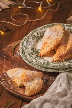 A crescent-shaped pastry whose filling is made of eggs and almonds wrapped in crispy dough, cut in an artisanal way and sprinkled with sugar.