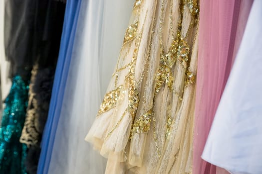 Different wedding dresses on hangers in boutique