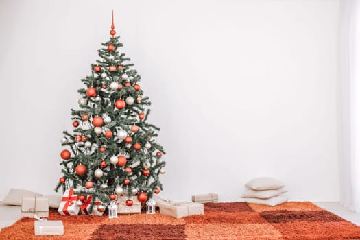 Christmas tree in the white room of the House for Christmas with gifts