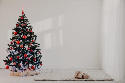 Christmas tree in a white room for Christmas with gifts 2