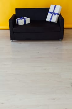 sofa with gifts in the interior of the yellow room