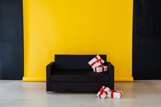 sofa with gifts in the interior of the yellow room