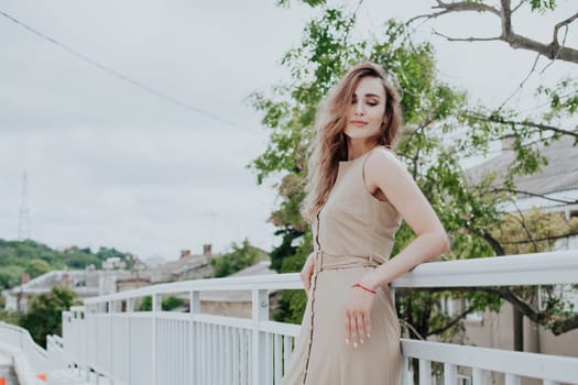 Portrait of a beautiful fashionable woman in a beige dress