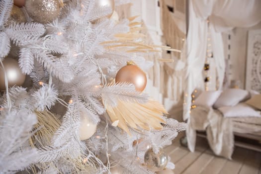 White Christmas decoration with balls on fir branches with blurred background