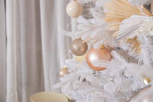 White Christmas decoration with balls on fir branches with blurred background