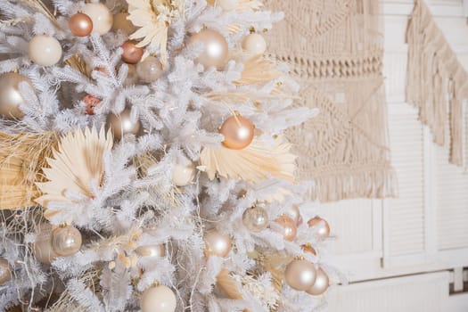 White Christmas decoration with balls on fir branches with blurred background