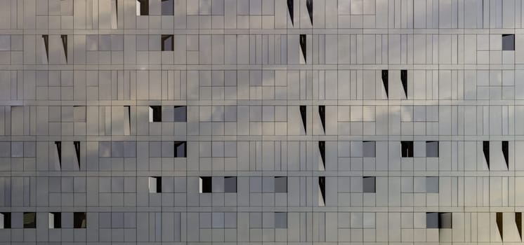 Liverpool, UK - Oct 07, 2023 - Sky reflection on Glass wall of Modern building with Repeating structure. Exterior architecture of building, Space for text, Selective focus.