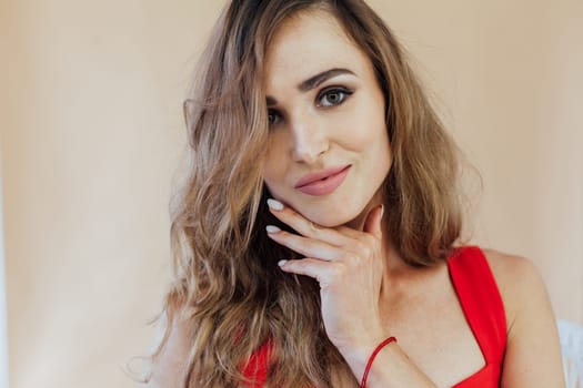 Portrait of a beautiful fashionable woman in a red business suit