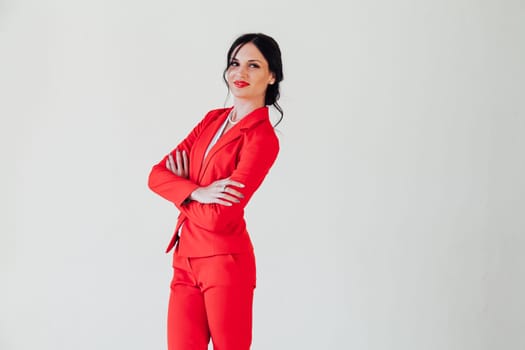 Portrait of a woman in a red business suit in a white room