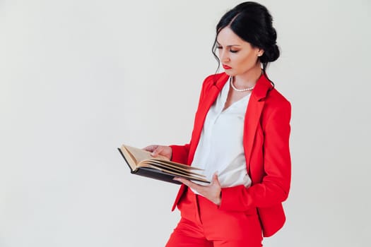 portrait of a woman in a red business suit with books