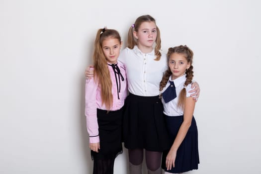 three schoolgirls in class at the school