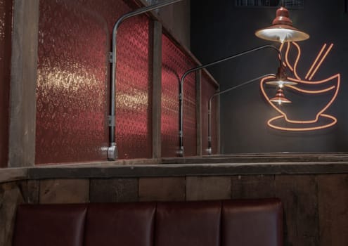 Liverpool, England - Oct 07, 2023 - Architecture design inside of Pho restaurants. Decorated with Glass wall, Hanging lamp and Wooden dining tables and upholstered chairs. Space for text, Selective focus.