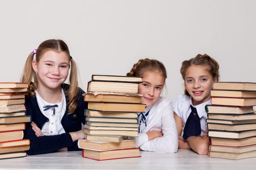 three girls in class at school with books