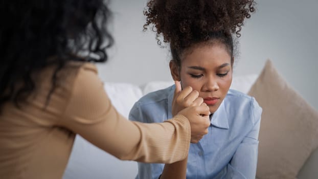 Sad PTSD woman patient in crucial therapy for mental health with psychologist, depression or grief after life failure. Frustrated trauma young woman talking to a psychologist about emotion in clinic
