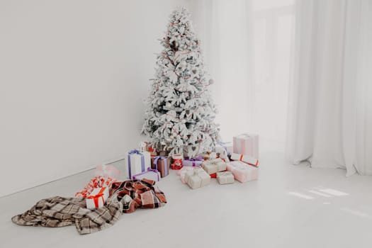 the Interior of the white room with a Christmas tree and Christmas gifts 8