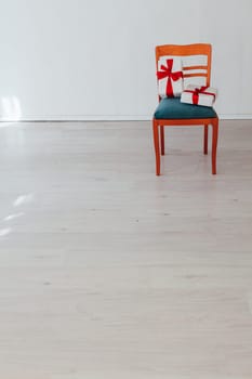 chair with present in the interior of the white room