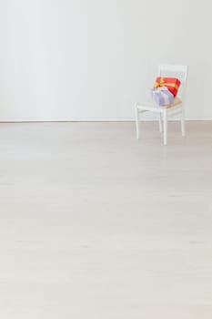 chair with present in the interior of the white room